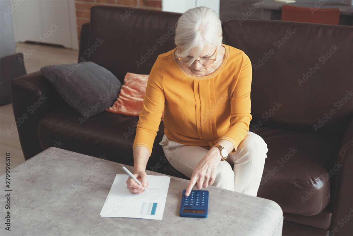 Senior-woman-with-calculator-and-bills-counting-1